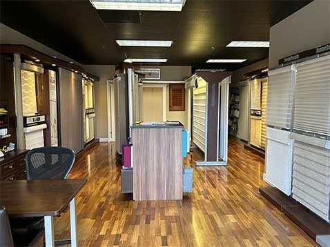 Store interior showcasing several different types of window coverings